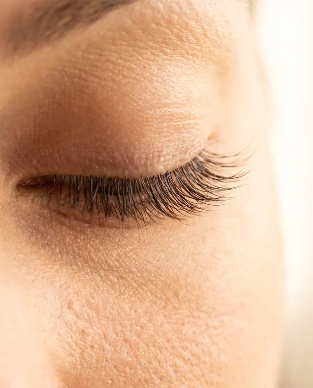Close-up of a closed eye with a flawless classic eyelash extension set