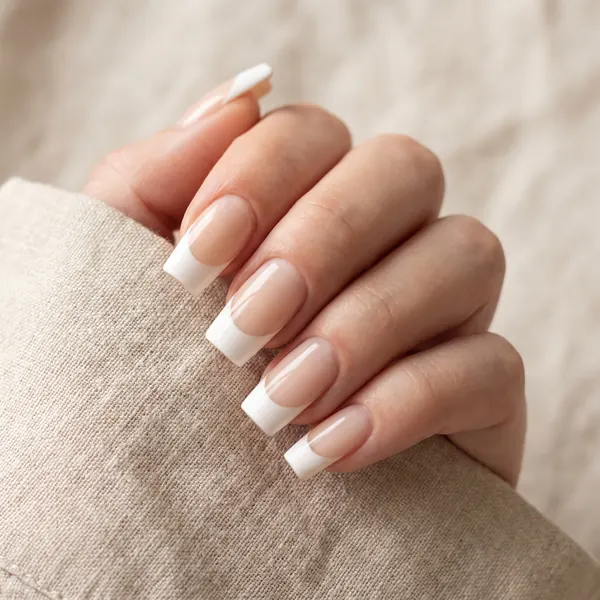 Medium square nail extensions with a crisp soft-white French tip