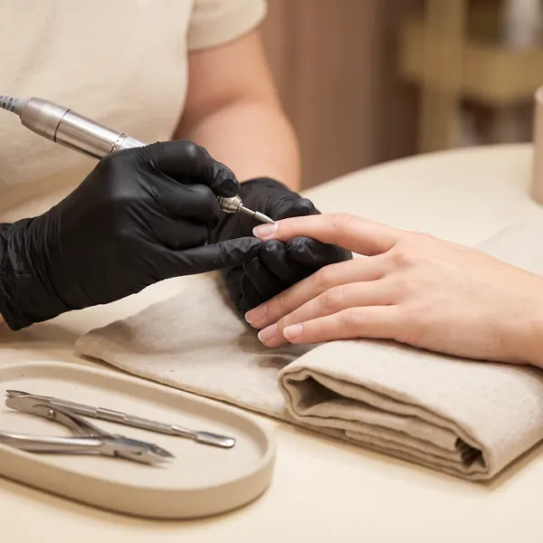 Technician performing a dry Russian manicure with an e-file